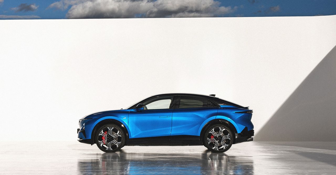 "Alpine A390 driving on a winding road with a scenic backdrop"