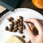 A person holding a healthy snack, symbolizing mindful eating for blood sugar control.