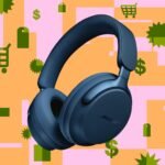 Bose QC Ultra Headphones with a person wearing them on a plane.