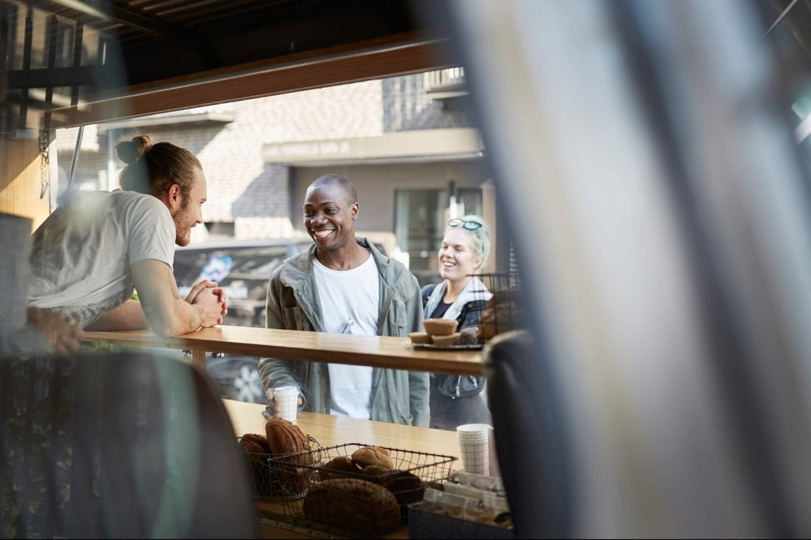 Alt text for the image - A photo of a bustling bagel shop with customers and staff working together.