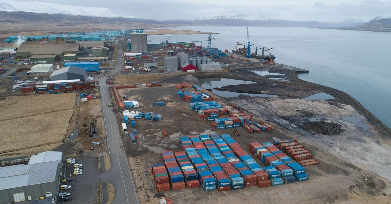 A photograph of a pile of leftover wood chips at Grundartangi harbor in Hvalfjörður, Iceland.