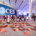 A futuristic display showing various tech gadgets and the CES 2026 logo, symbolizing innovation.