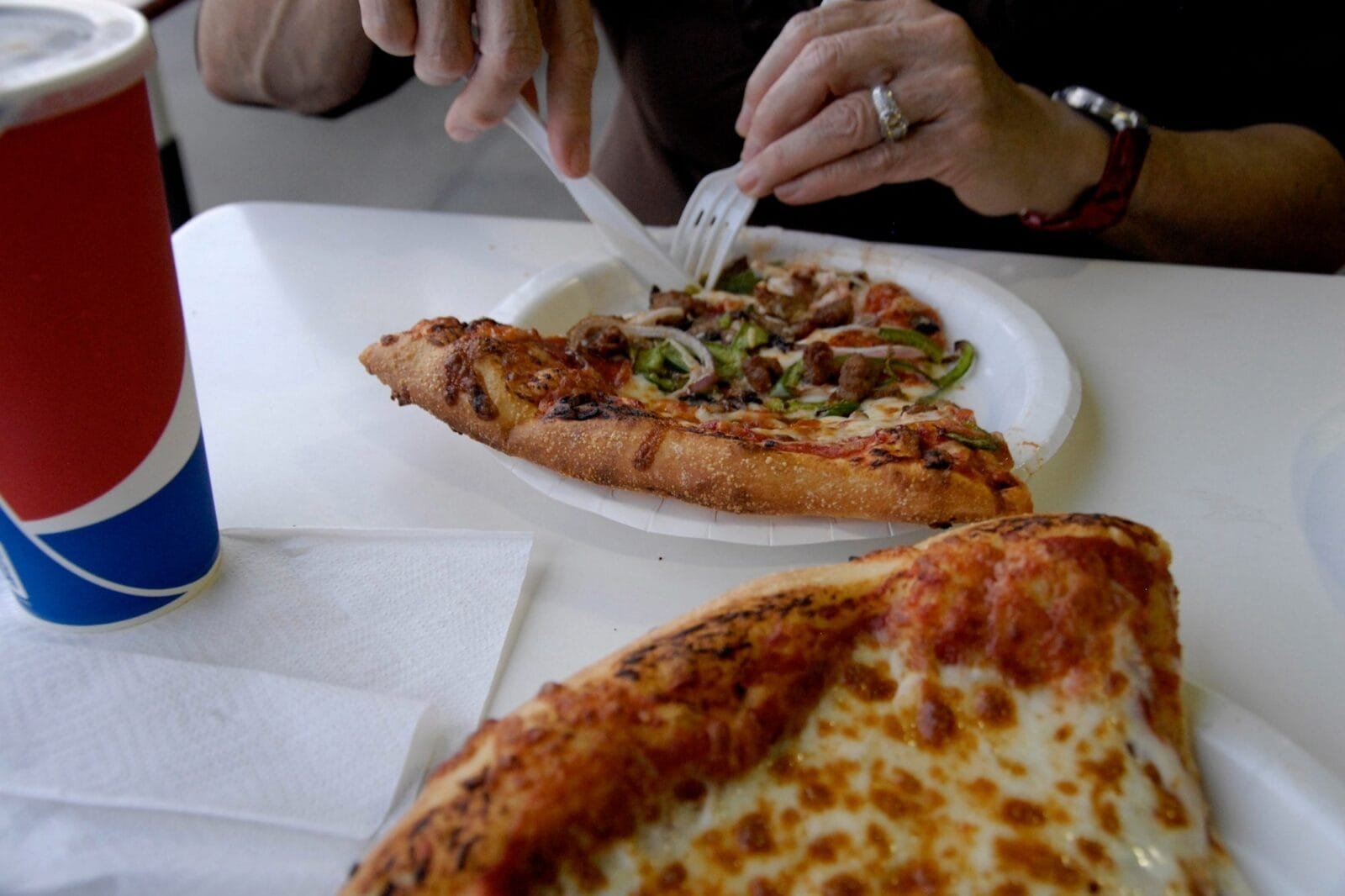 Costco customers enjoying pizza in the food court.