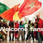 Supporters de la Coupe d'Afrique des Nations suivant un match en direct dans une Fan zone d'aéroport.