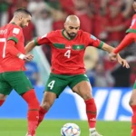 **وصف الصورة: منتخب المغرب يهز جسده في المباراة الافتتاحية لكأس الأمم الأفريقية لكرة القدم.**