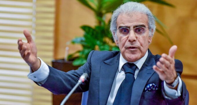 وصف الصورة بالإنجليزية: "صورة لشخص يقرأ خبرًا عن سعر الفائدة الرئيسي"