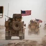 صورة لمركبات عسكرية أمريكية تسير قرب حقل نفط في منطقة الرميلان وسط عاصفة رملية في محافظة الحسكة شمالي شرق سوريا.