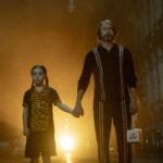 Alt text for the image: A young girl standing in front of a monster under her bed, with a hitman standing next to her.