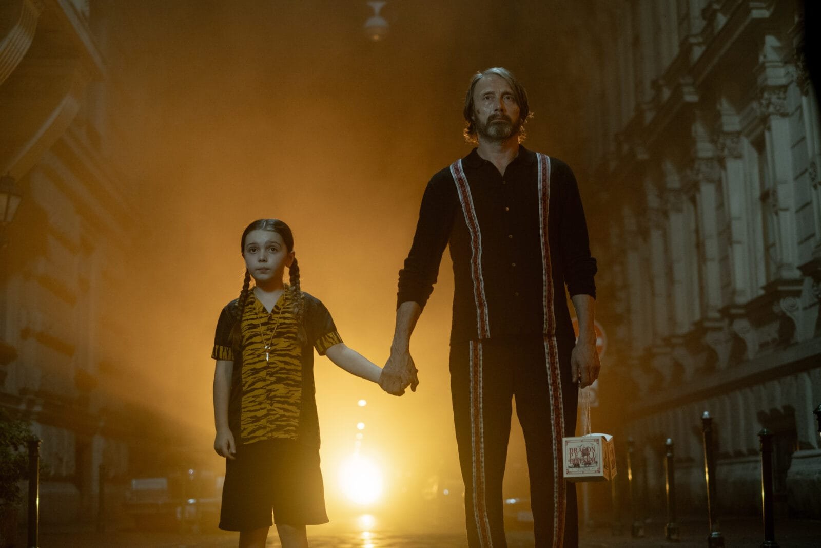 Alt text for the image: A young girl standing in front of a monster under her bed, with a hitman standing next to her.