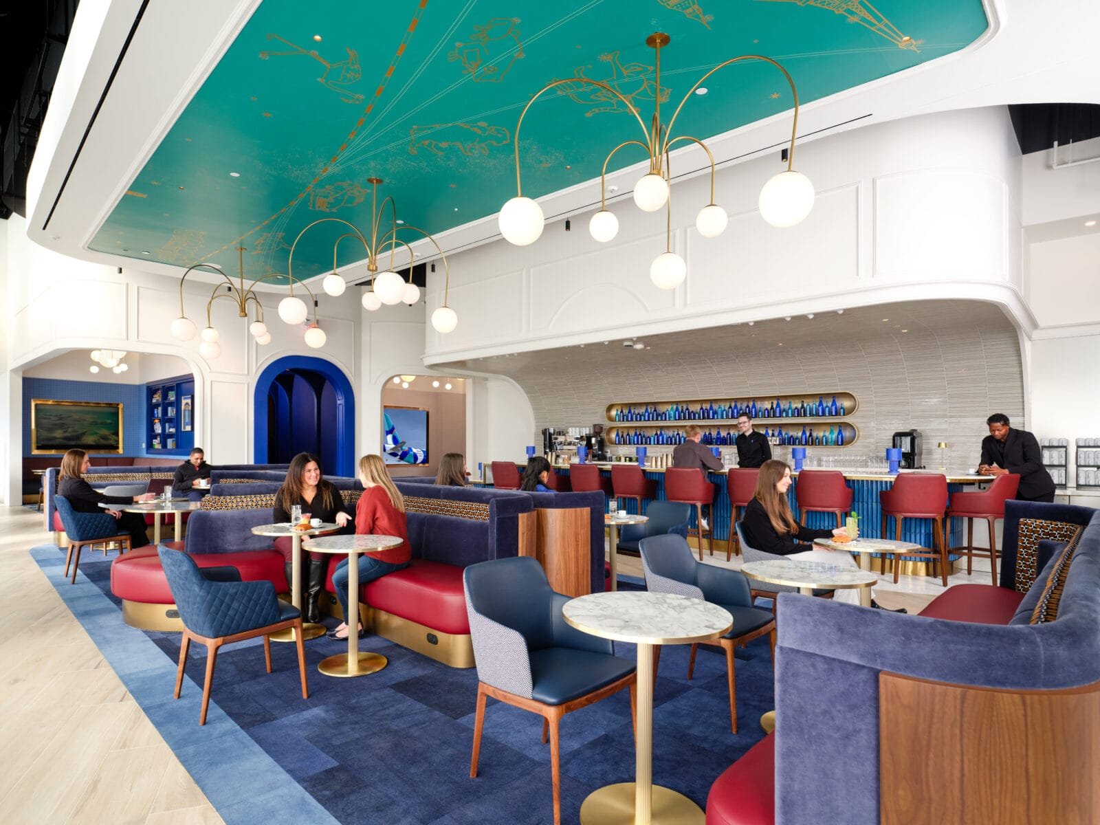 JetBlue unveils first ever airport lounge, BlueHouse. Here's what's inside 1 JetBlue BlueHouse lounge interior with art deco design and comfortable seating areas.