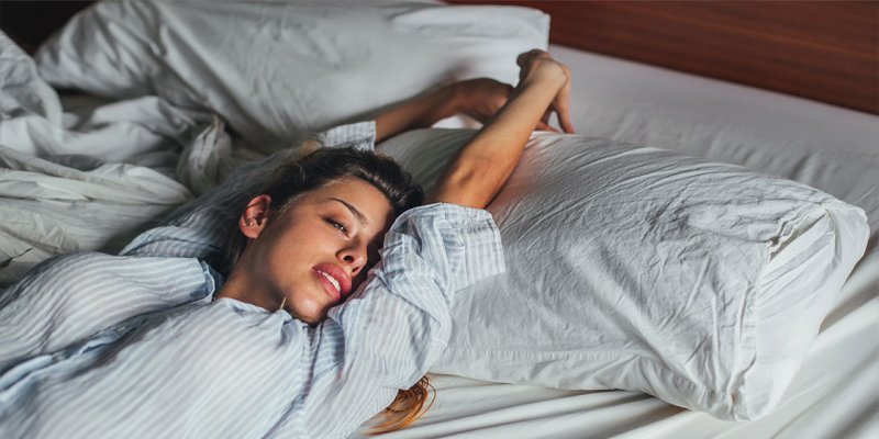 Alt text for the image: "Sleeping person with a brain in the background"