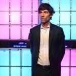 Nick Thompson running in a park, with a determined look on his face.