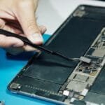 This Group Pays Bounties to Repair Broken Devices—Even If the Fix Breaks the Law 6 A group of people working together to repair a device.