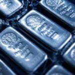 Elon Musk looking concerned amidst a backdrop of market charts, symbolizing rising silver prices and industrial impact.