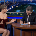 Taylor Swift and Stephen Colbert brainstorming a mystery novel together