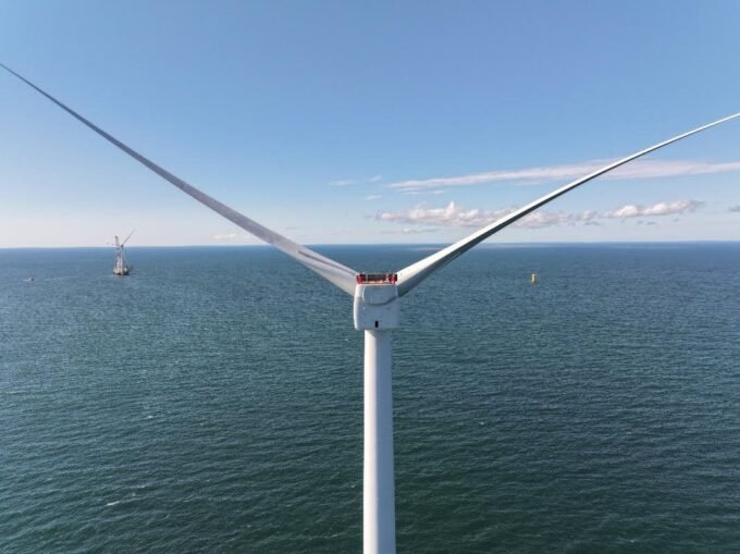 Offshore wind turbines in the distance, with a radar station in the foreground.
