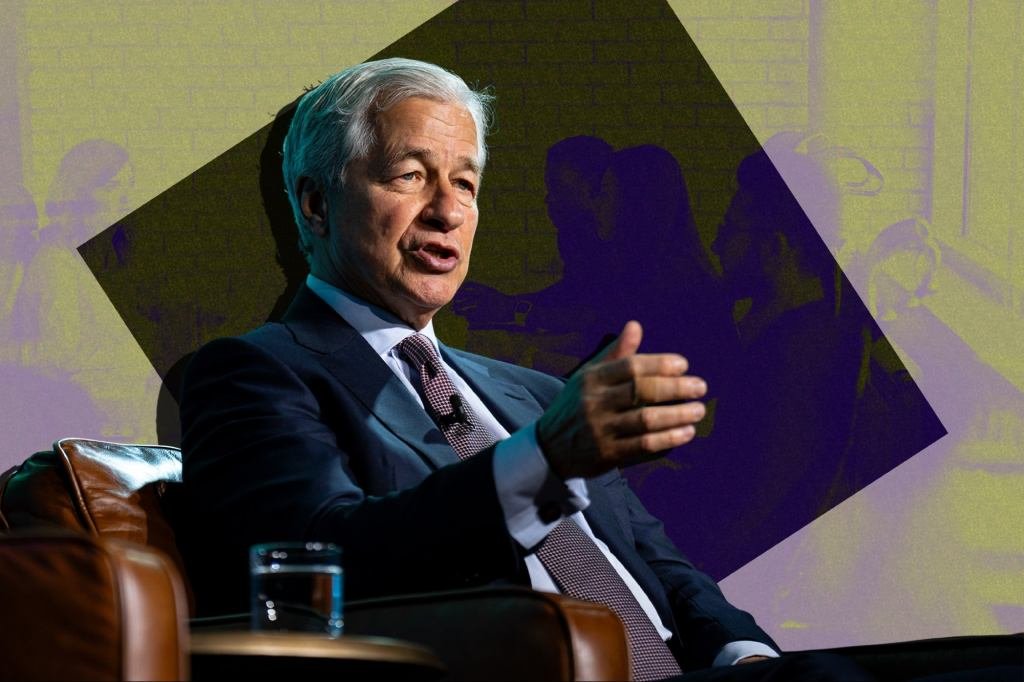 Jamie Dimon, CEO of JPMorgan Chase, in a focused stance during a meeting, emphasizing presence.