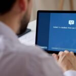 A professional individual confidently using a laptop with AI-related graphics, symbolizing career growth and technological advancement.