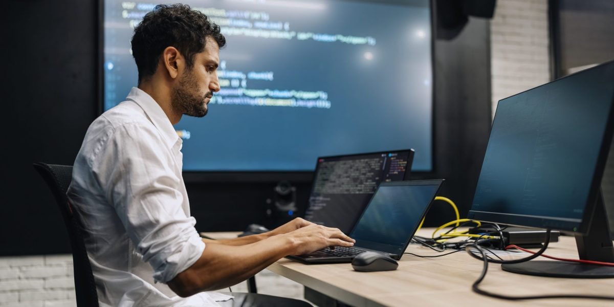 The AI Productivity Paradox: Why Seasoned Developers Took Longer, Not Less Time, With Assistance 3 A software developer looking frustrated while working on a computer, with AI-related graphics overlaid.