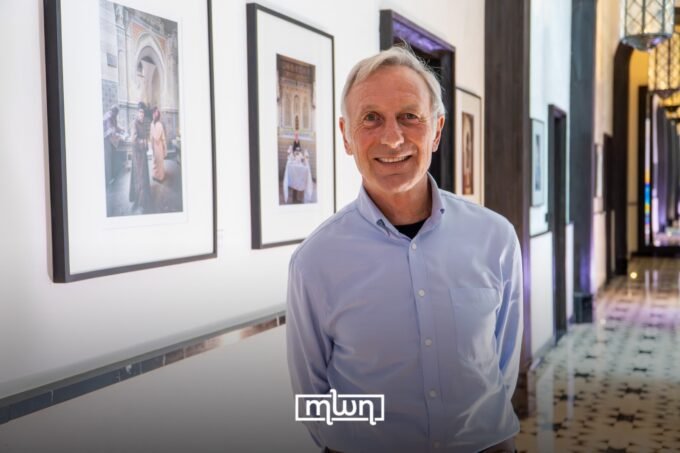British photographer Alan Keohane stands amidst his 'Our Land – Ardna' exhibition showcasing Moroccan landscapes and portraits.