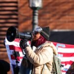 From Cat Bongos to Combat Vets: The Unprecedented Coalition Rising Against ICE 8 Protestors demonstrating against ICE with signs in a city street, photo by Steven Garcia / The Verge.