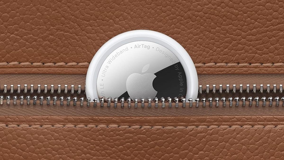 A four-pack of Apple AirTags displayed with one AirTag detached, highlighting its compact and sleek design.