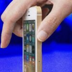 An old iPhone 5S displaying the iOS update screen, symbolizing Apple's continued support for legacy devices.