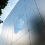 Apple logo next to Microsoft logo, symbolizing the comparison of their business models