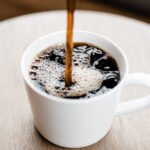 Close-up of roasted Arabica coffee beans, highlighting their rich color and texture