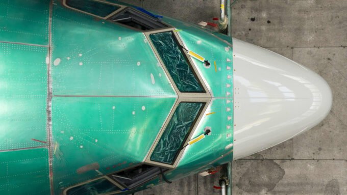 A Boeing 737 Max aircraft on the tarmac at a manufacturing facility, symbolizing the company's increased production and delivery numbers.