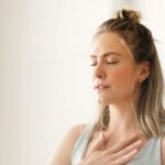 A person practicing breathwork in a serene setting, symbolizing emotional release and inner peace.