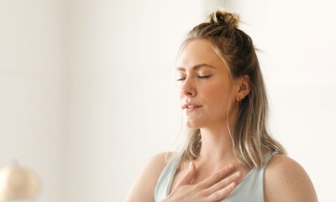 A person practicing breathwork in a serene setting, symbolizing emotional release and inner peace.