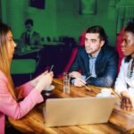 Two business people shaking hands, symbolizing respect and partnership in a professional setting.