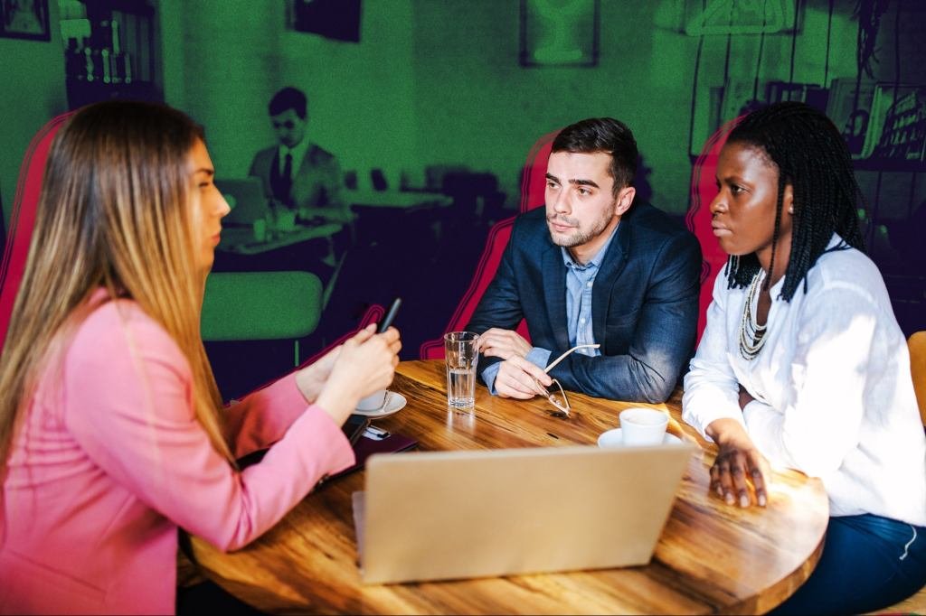 Two business people shaking hands, symbolizing respect and partnership in a professional setting.