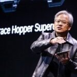Nvidia CEO Jensen Huang smiling, wearing a black jacket