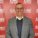 Vue aérienne d'un stade de football moderne au Maroc, symbolisant l'organisation de la CAN 2025 et son rayonnement.