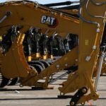 Caterpillar heavy machinery on a construction site, symbolizing industrial strength and global trade.