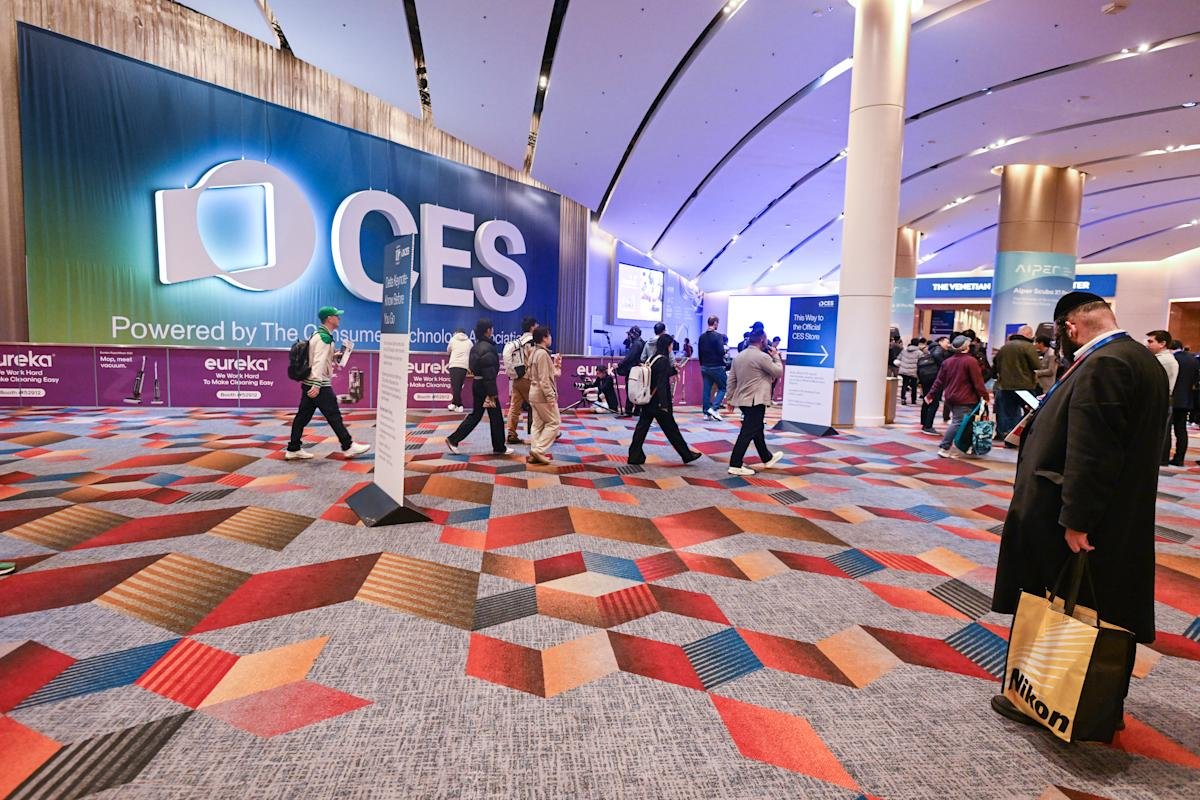 A vibrant shot of the Las Vegas Convention Center during CES, with attendees exploring futuristic tech displays.