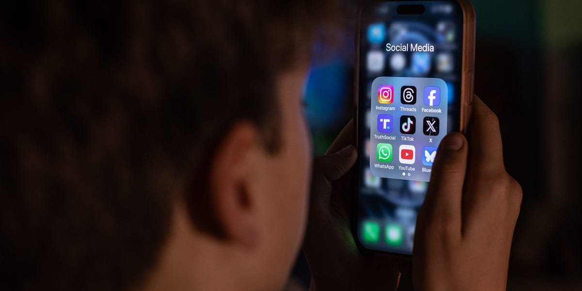 A child looking at a smartphone, with a parental control icon overlayed, symbolizing restrictions on social media access.