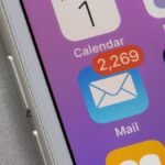 A person's head with gears and digital information swirling around it, symbolizing cognitive overload and mental exhaustion.