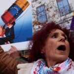 علم فنزويلا وخلفه أعلام دول أمريكا اللاتينية وإسبانيا، أو خريطة المنطقة مع إشارة للتوترات السياسية.