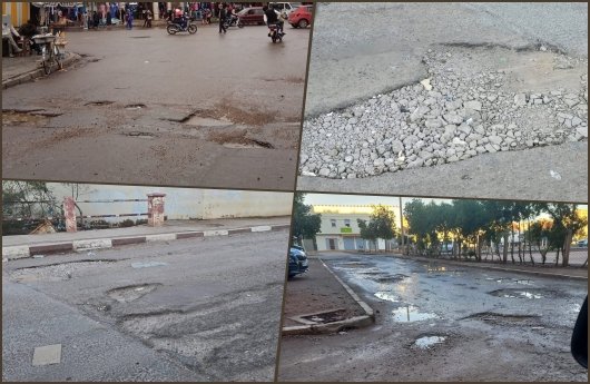 صورة لشارع مهترئ في مدينة وجدة يظهر الحفر والتشققات بعد هطول الأمطار.