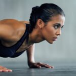 A person demonstrating a decline pushup with their feet elevated on a bench, focusing on proper form.