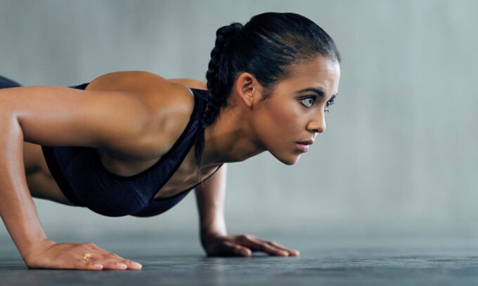 A person demonstrating a decline pushup with their feet elevated on a bench, focusing on proper form.