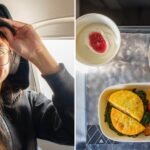 A passenger enjoying the spacious and luxurious Delta First Class cabin with a meal and entertainment.