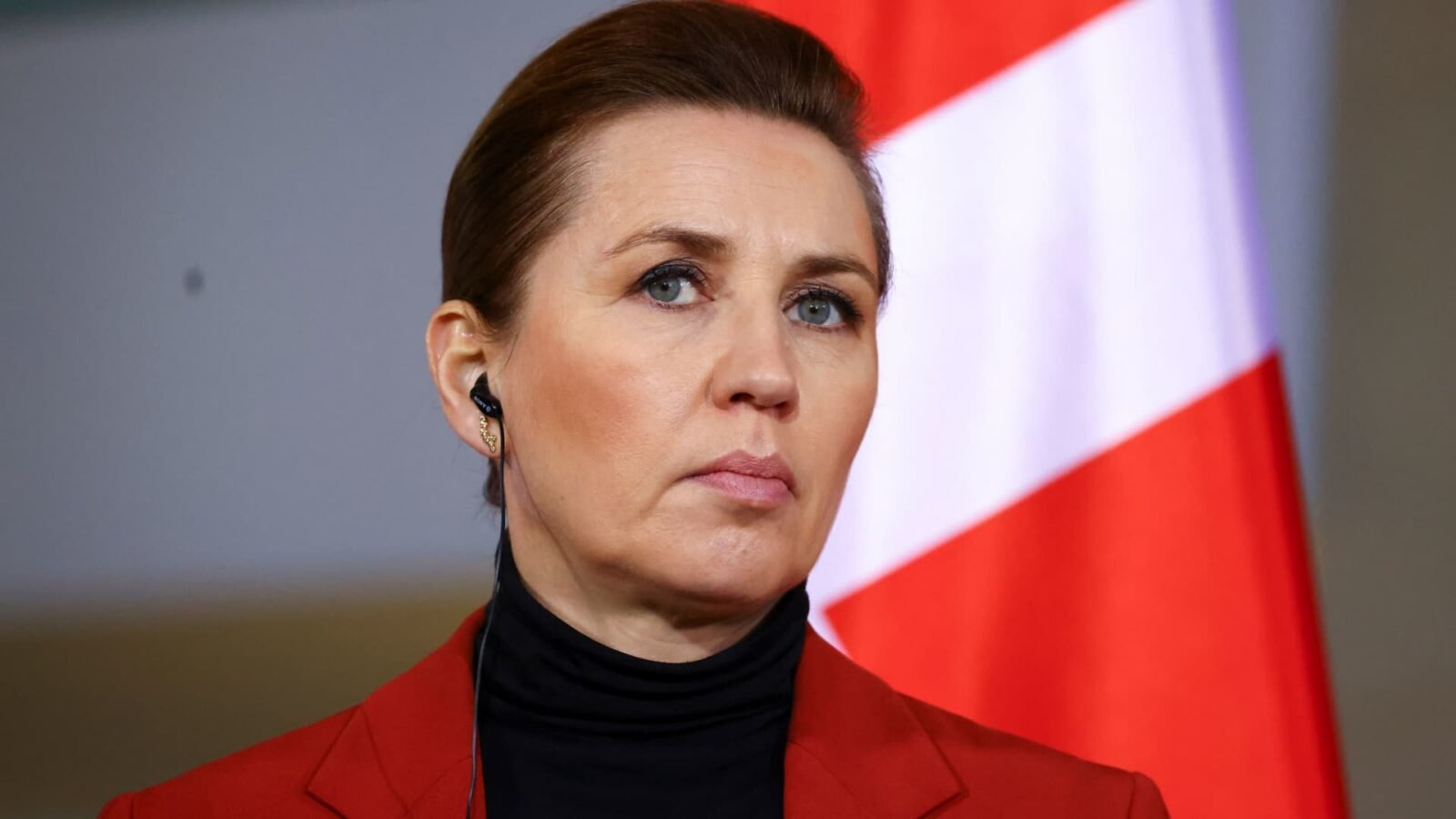 Danish Prime Minister Mette Frederiksen at a press conference, discussing Greenland's sovereignty amidst U.S. acquisition threats.