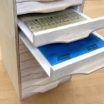 DIY sandpaper flat file storage cabinet filled with various grits and sanding accessories.