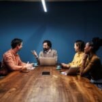 A person standing confidently on a mountain peak, symbolizing ownership, leadership, and vision in entrepreneurship.