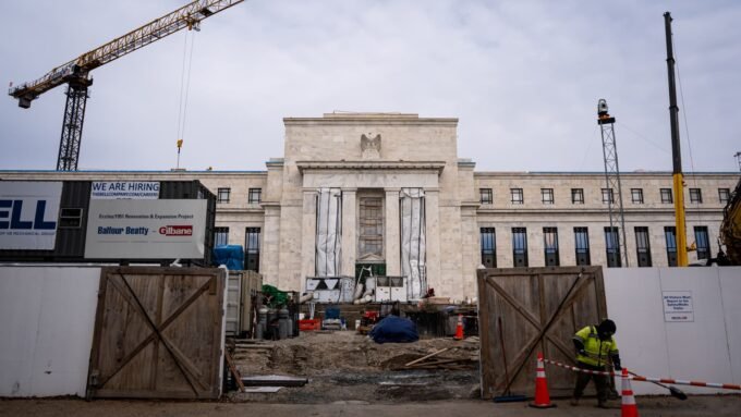 Federal Reserve building with a graph showing declining interest rates, symbolizing Mark Zandi's forecast.