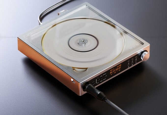 FiiO DM15 R2R portable CD player in its leather case, showcasing a spinning CD under a tempered-glass lid.